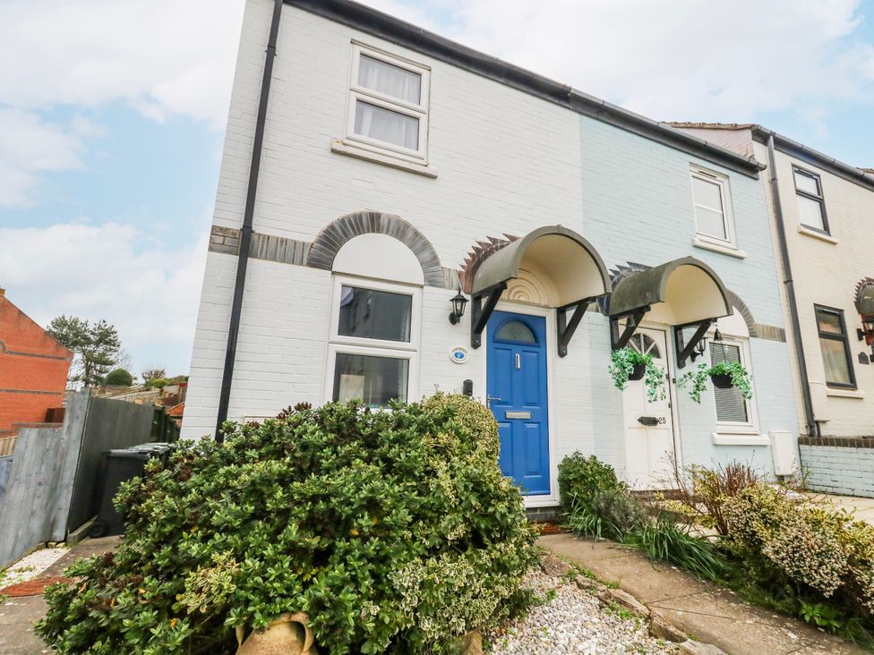A house with a blue front door and pathway at 23 The Maltings in Weymouth