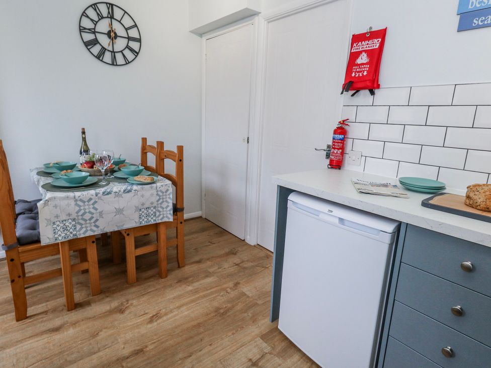 A kitchen with a dining table set for a meal at 23 The Maltings Weymouth