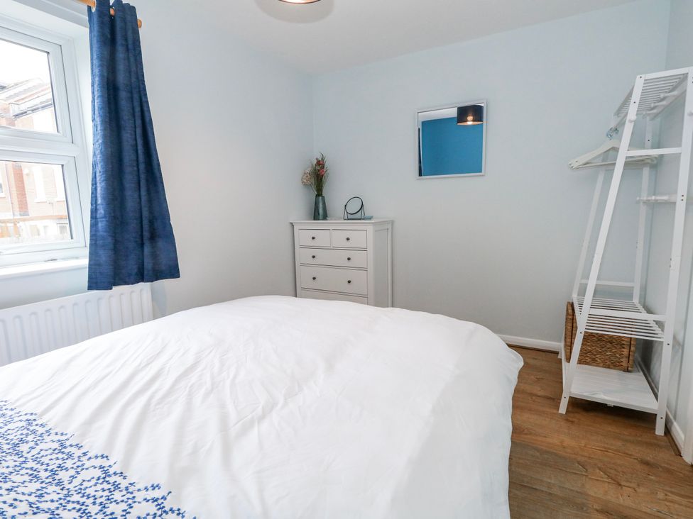 A bedroom with a bed and a dresser at 23 The Maltings in Weymouth