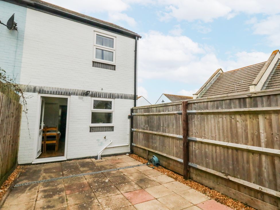 A patio area with a fence and door at 23 The Maltings in Weymouth
