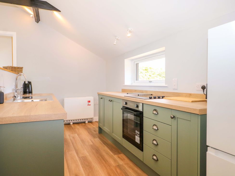 A kitchen with a sink and stove at The Old Parlour in Southampton