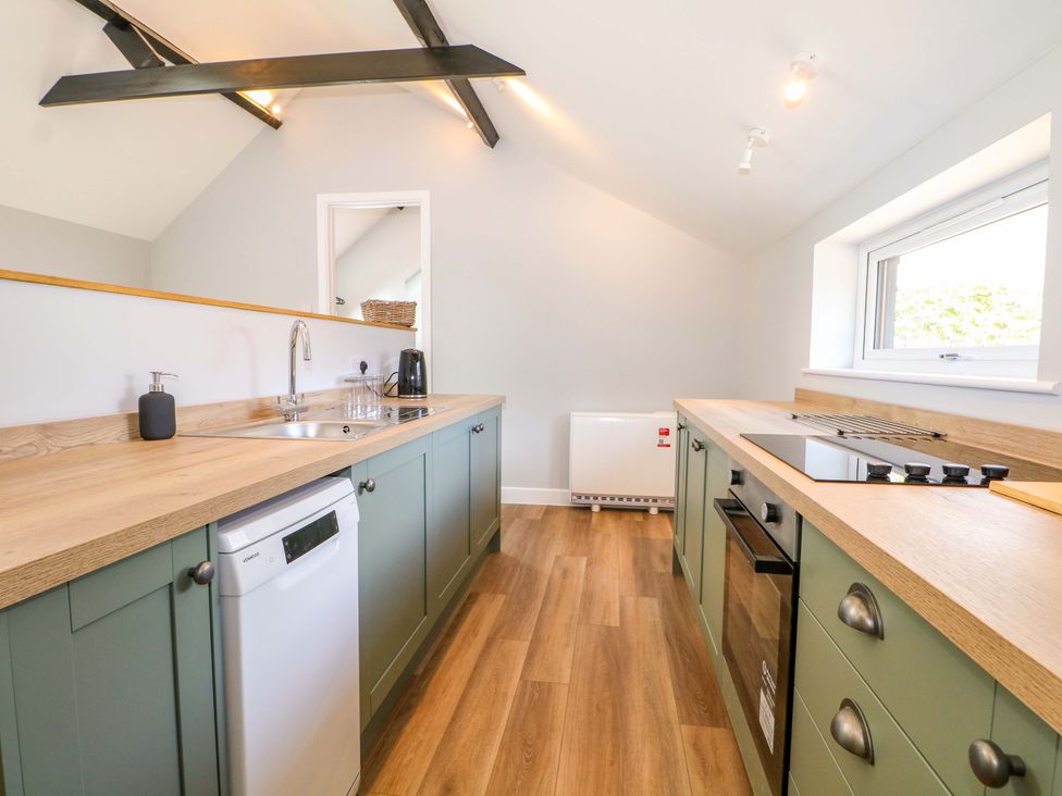 A kitchen with a sink and cabinets at The Old Parlour Southampton