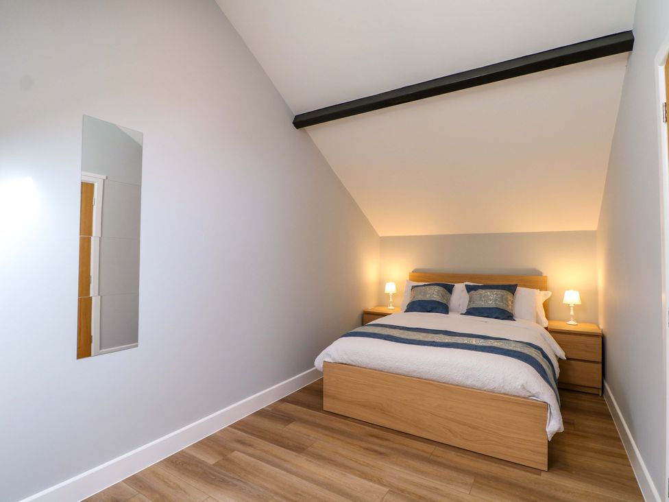 A bedroom with a bed and lamps at The Old Parlour Southampton