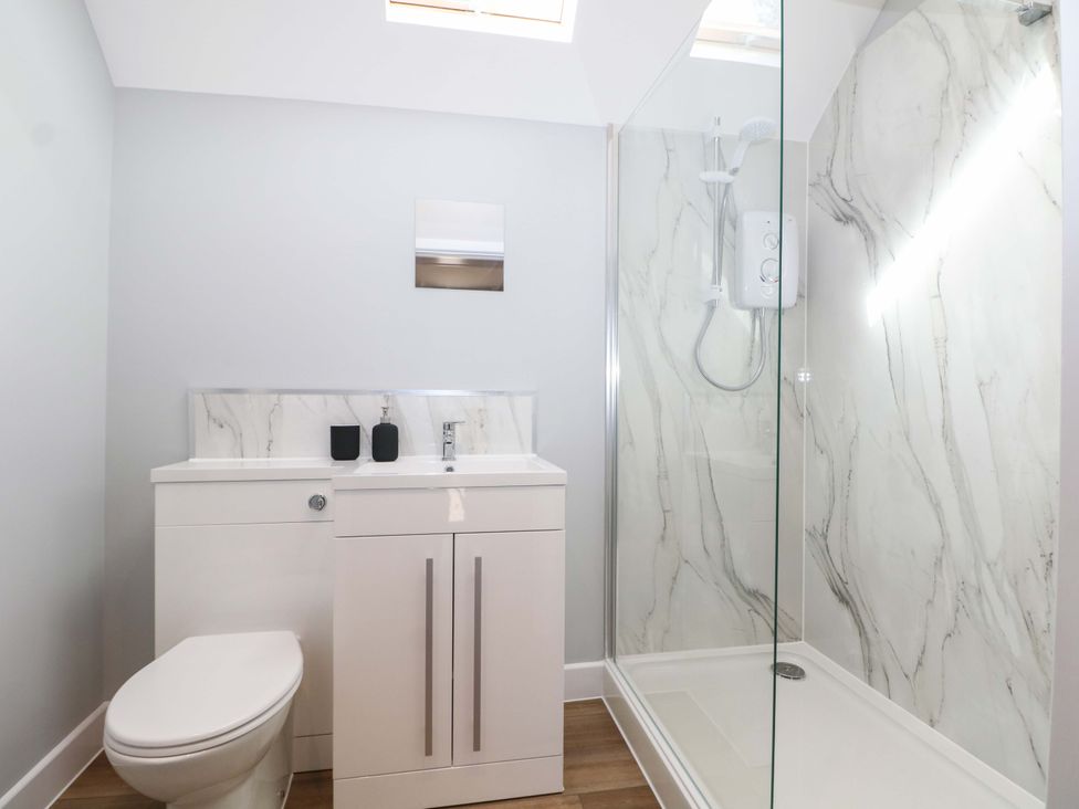 A bathroom featuring a toilet, sink, and shower at The Old Parlour in Southampton