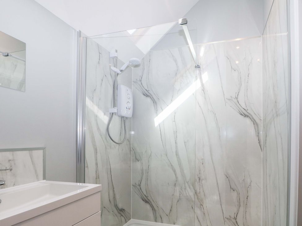 A bathroom with a shower and mirror at The Old Parlour in Southampton