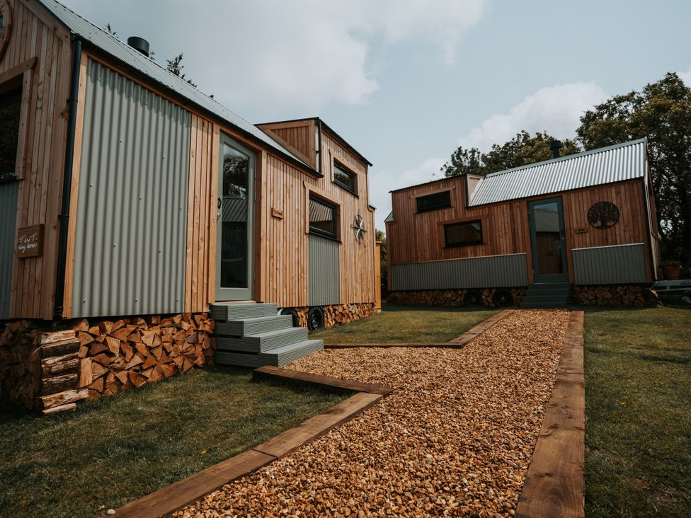 Two wooden houses with gravel path at Rowan in Carreglefn near Llanfechell