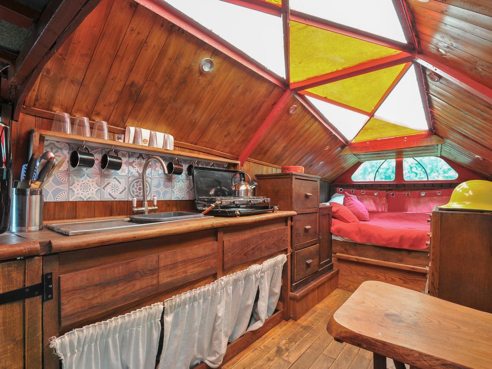 A kitchen with a stove and sink at Dashing Dennis - 22 Chapmanswell near Launceston