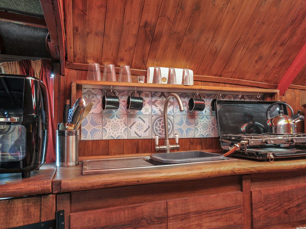 A kitchen with a sink, kettle, and stove at Dashing Dennis - 22 in Chapmanswell near Launceston