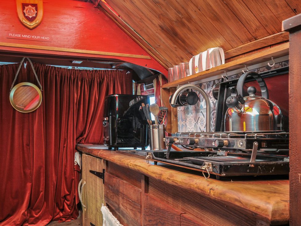 A kitchen with a coffee maker and stove at Dashing Dennis - 22 Chapmanswell near Launceston