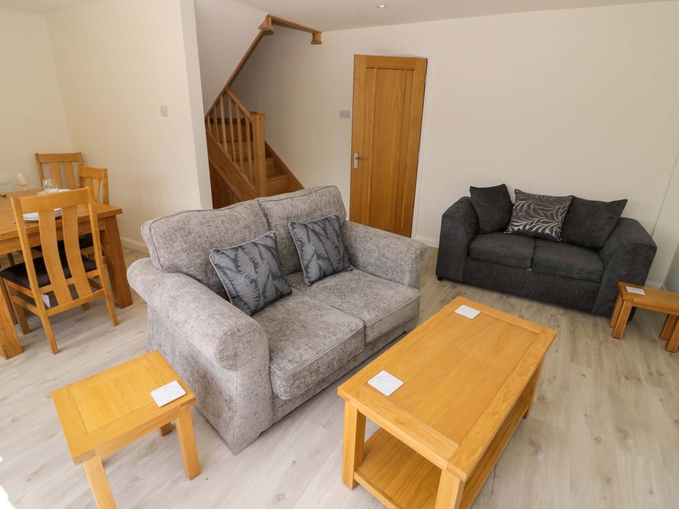 A living room with a sofa, coffee table, and dining area at 22 Old Chapel Close Kidlington