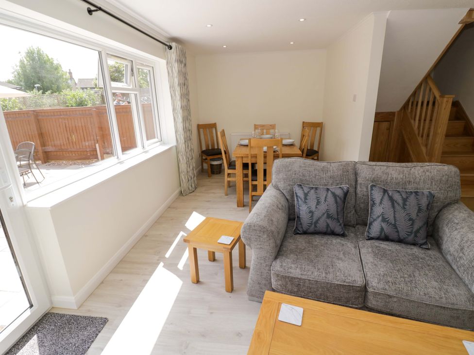 A living room with a sofa and dining table at 22 Old Chapel Close, Kidlington