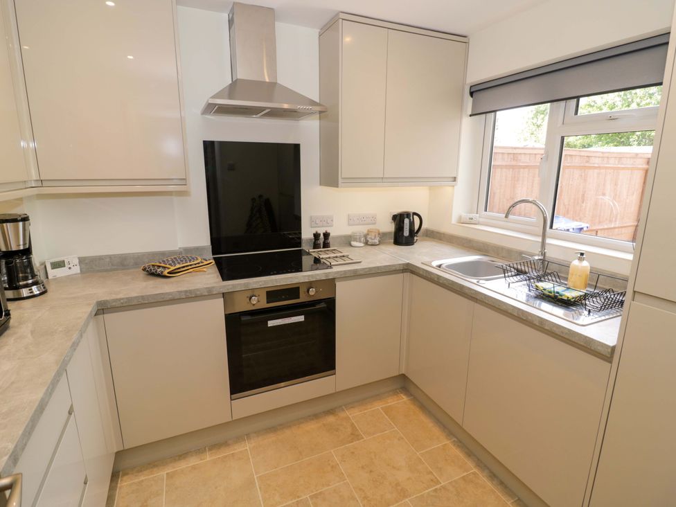 A kitchen with countertops, stove, and sink at 22 Old Chapel Close in Kidlington