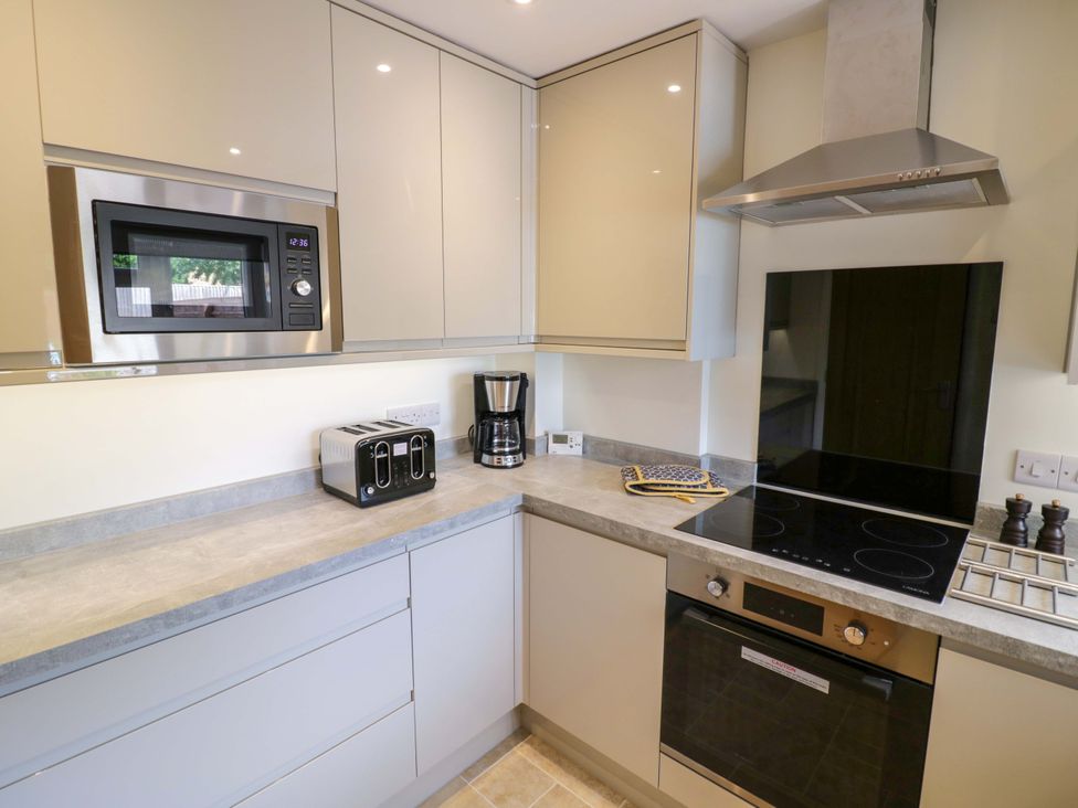 A kitchen with appliances including a microwave and coffee maker at 22 Old Chapel Close Kidlington