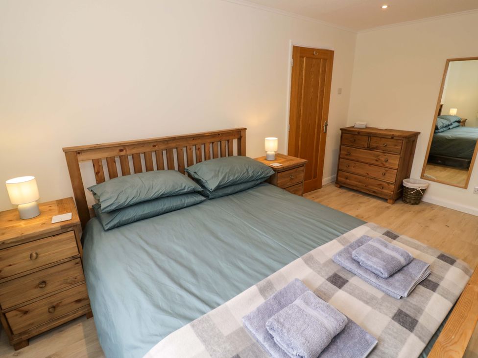 A bedroom with a bed, nightstand, and dresser at 22 Old Chapel Close in Kidlington