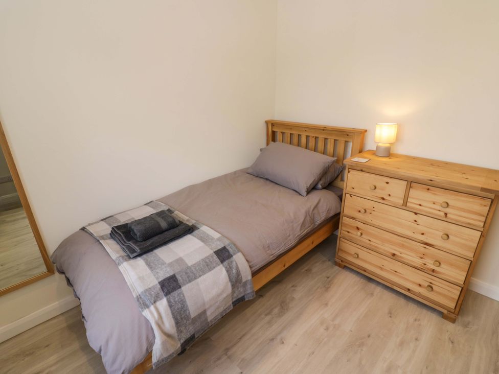 A bedroom with a bed and dresser at 22 Old Chapel Close in Kidlington