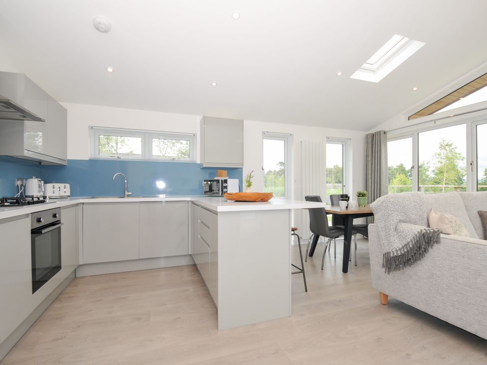 A kitchen with a dining table and chairs at 3 Meadow Retreat Liskeard