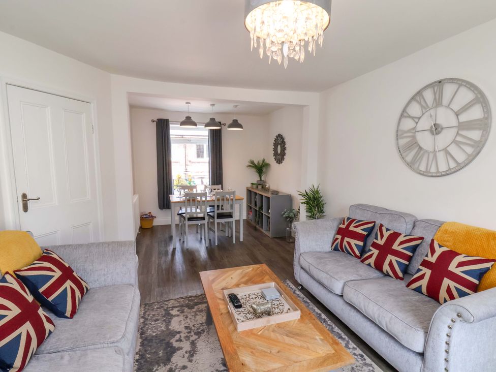 A living room with a coffee table and a dining area at Postman’s Lodge in Middlesbrough