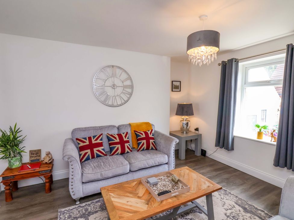A living room with a sofa and coffee table at Postman’s Lodge in Middlesbrough