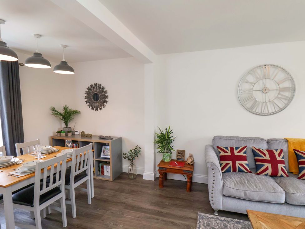 A living room with a dining setup and seating area at Postman’s Lodge in Middlesbrough