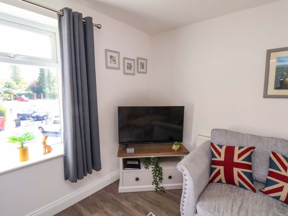 A living room with a television and sofa at Postman’s Lodge in Middlesbrough