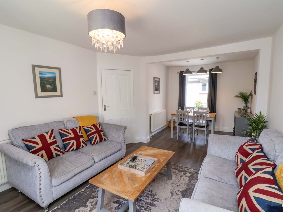 A living room with sofas and a dining area at Postman’s Lodge in Middlesbrough