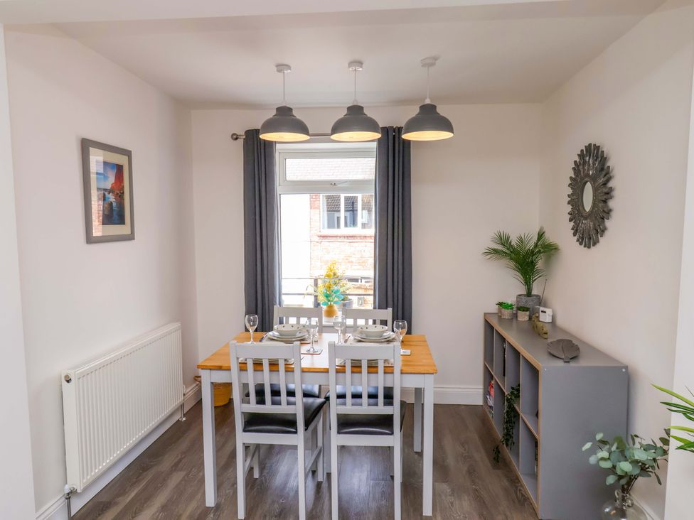 A dining room with a table and chairs at Postman’s Lodge in Middlesbrough