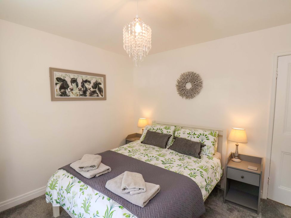 A bedroom with a bed and bedside lamps at Postman’s Lodge in Middlesbrough