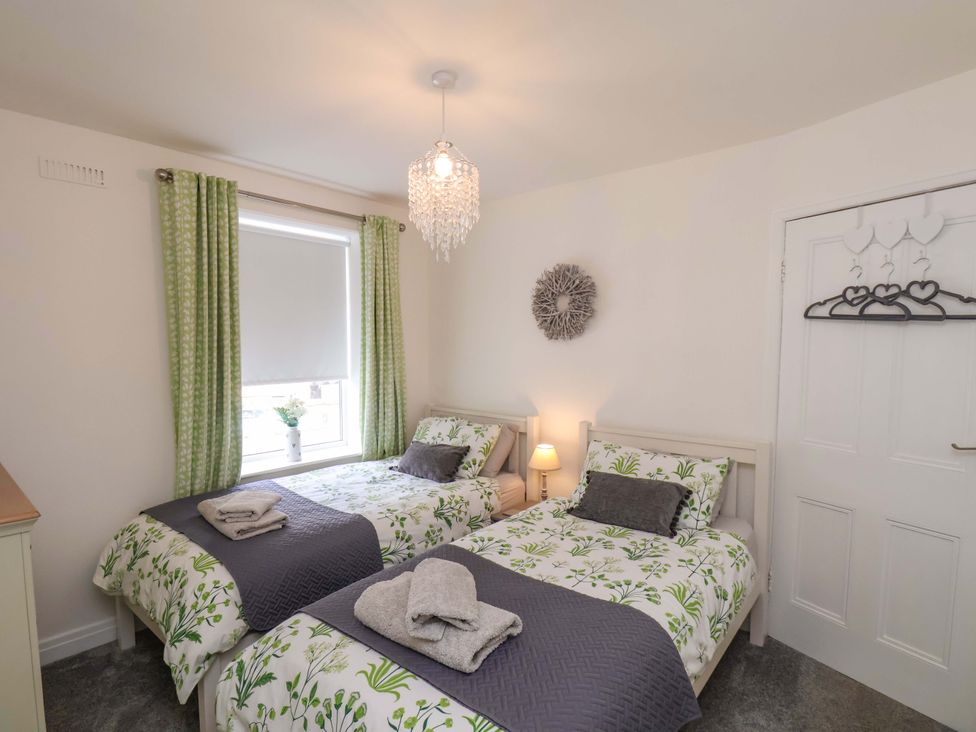 A bedroom with two beds and a window at Postman’s Lodge Middlesbrough