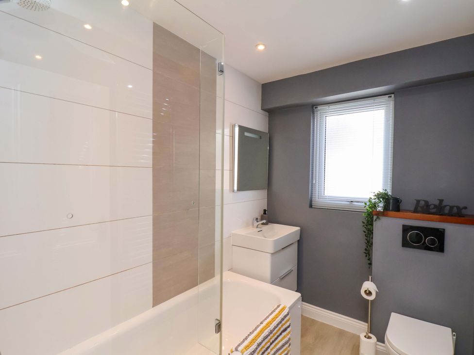 A bathroom with a bathtub and sink at Postman’s Lodge in Middlesbrough
