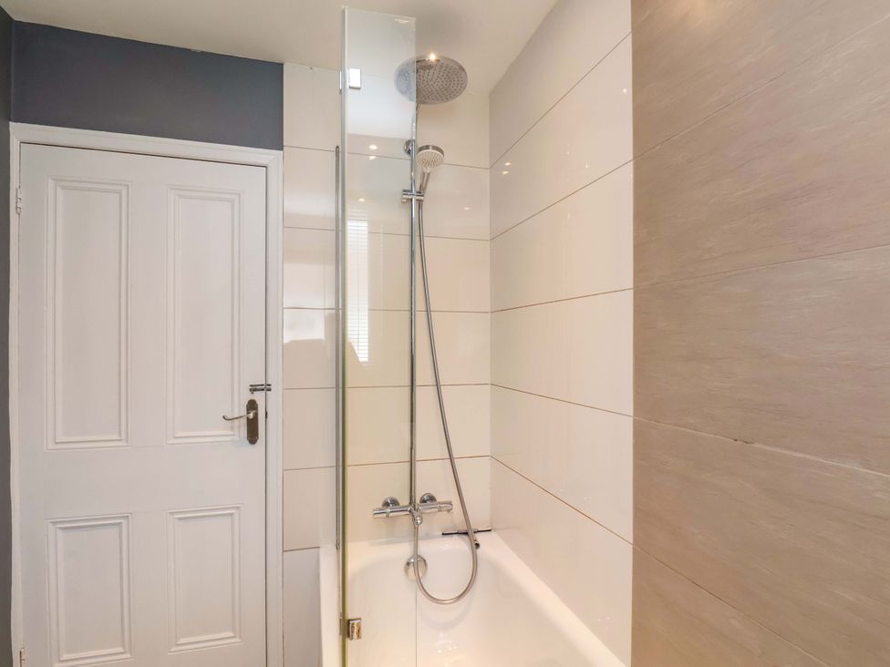 A bathroom with a shower and bathtub at Postman’s Lodge in Middlesbrough