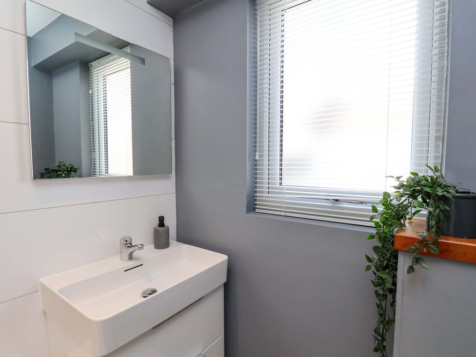A bathroom with a sink and a mirror at Postman’s Lodge in Middlesbrough