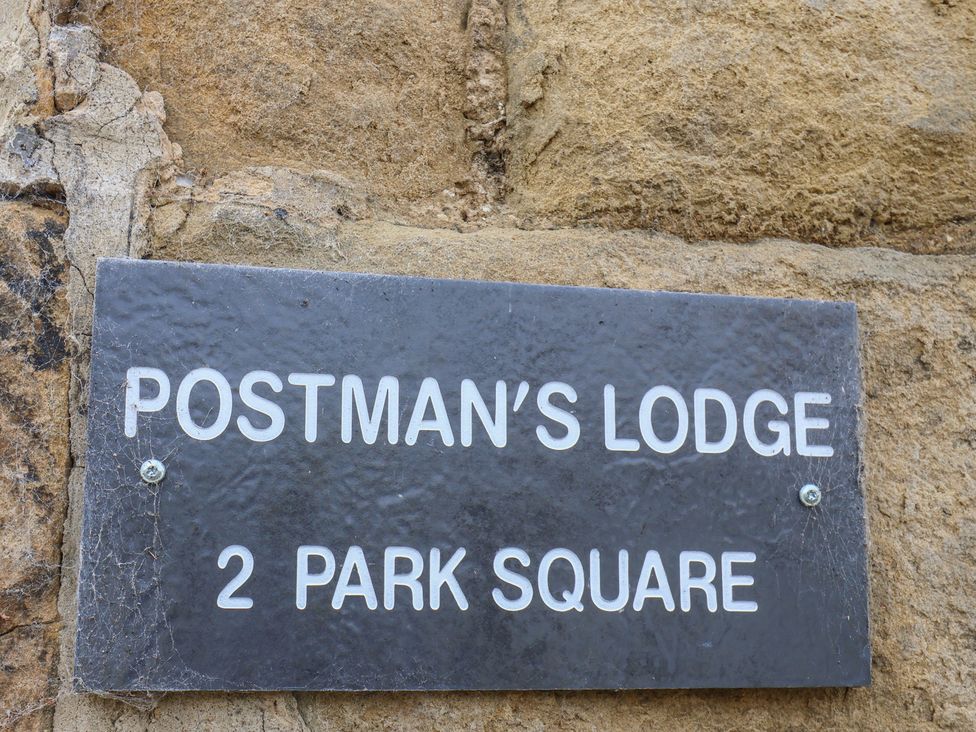 A nameplate displaying Postman's Lodge 2 Park Square in Great Ayton