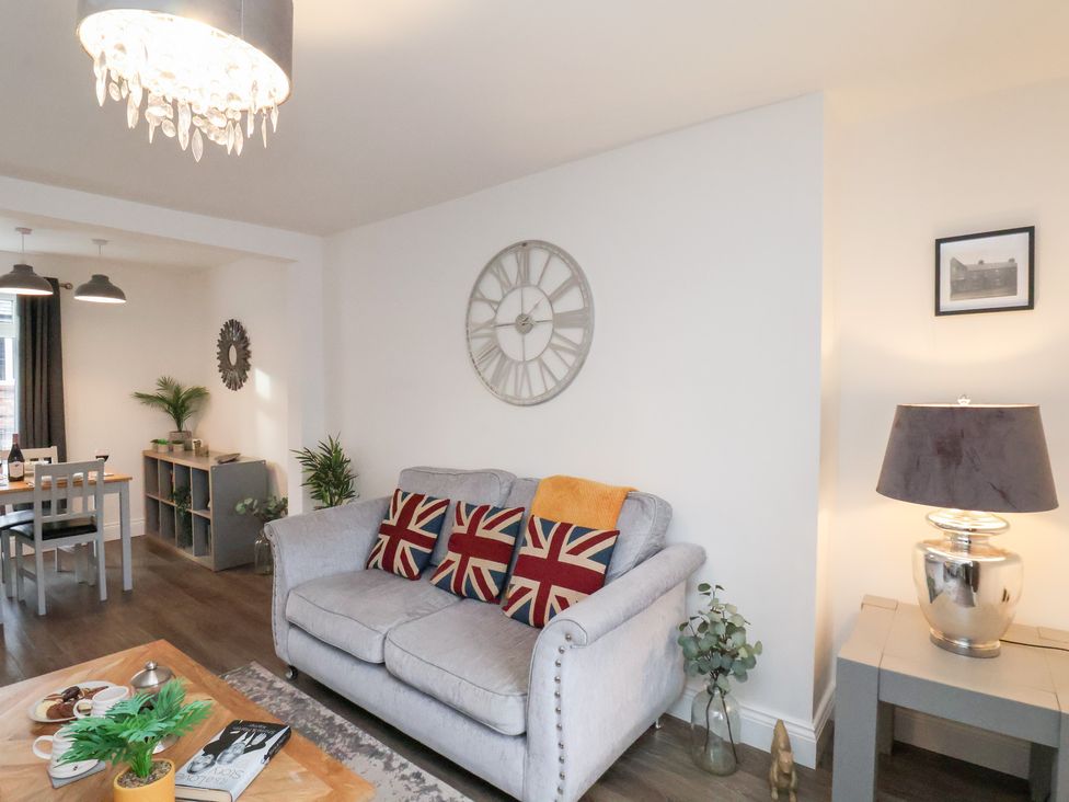 A living room with a sofa and coffee table at Postman’s Lodge in Great Ayton