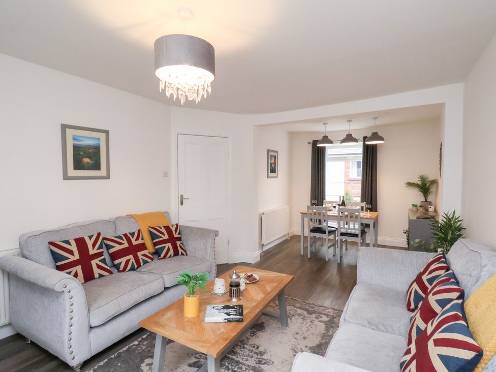 A living room with a sofa and coffee table at Postman’s Lodge in Great Ayton