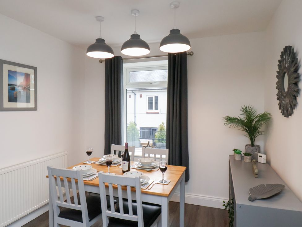 A dining room with a table set for dinner at Postman’s Lodge in Great Ayton