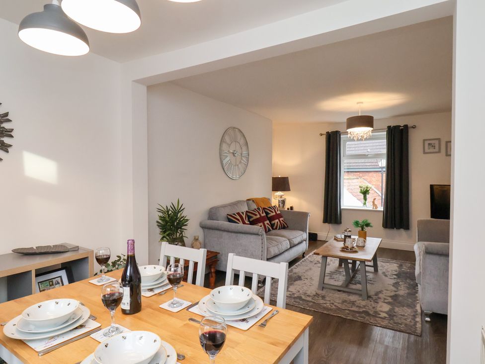 A dining area with a table set for dinner at Postman’s Lodge in Great Ayton