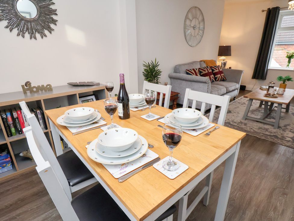 A dining room with a table set for dinner at Postman’s Lodge in Great Ayton