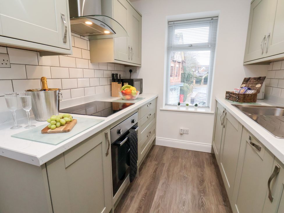 A kitchen with cooking range and sink at Postman’s Lodge in Great Ayton