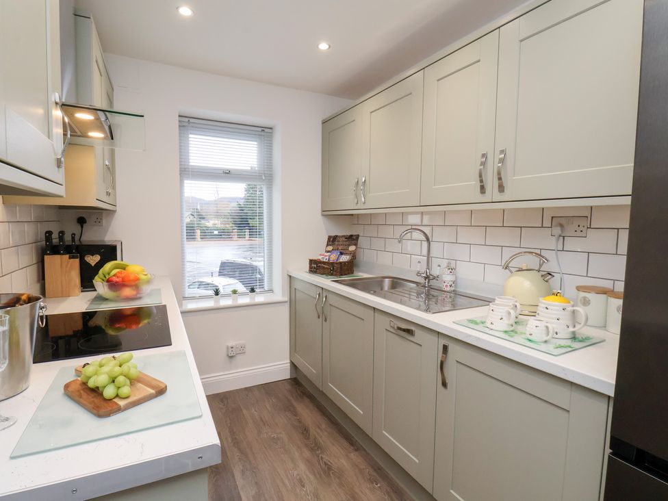 A kitchen with cabinets and a sink at Postman’s Lodge in Great Ayton