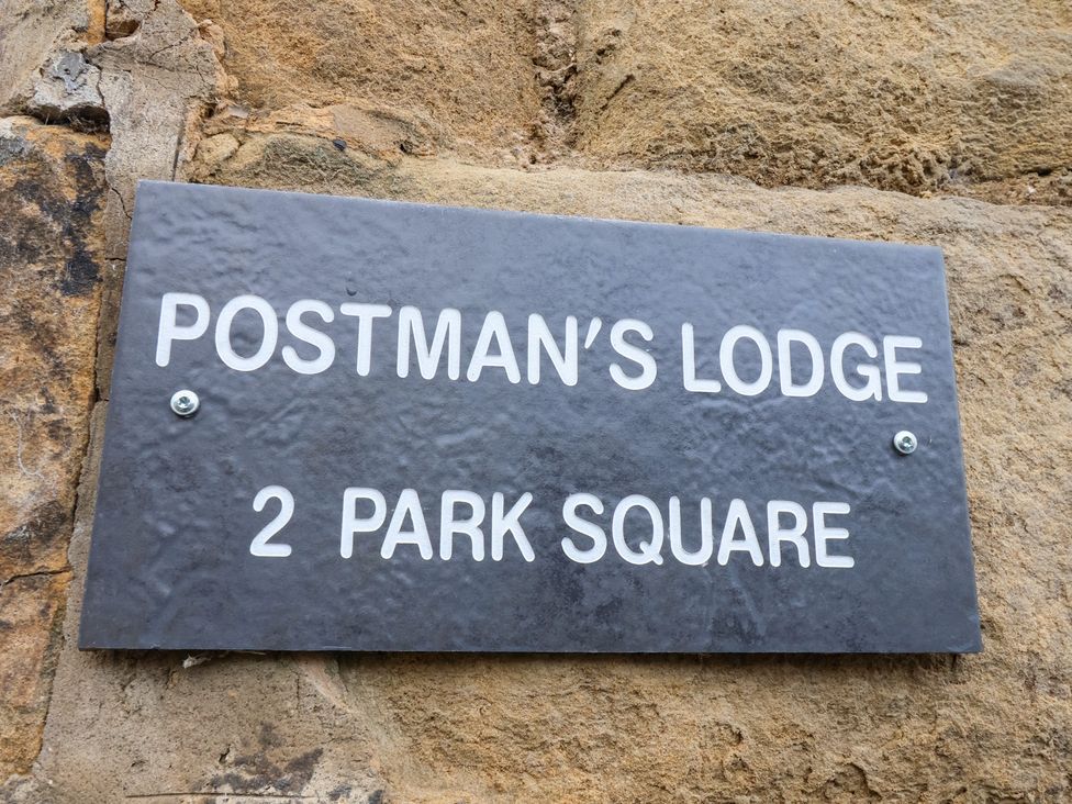 A sign for Postman's Lodge at 2 Park Square in Great Ayton