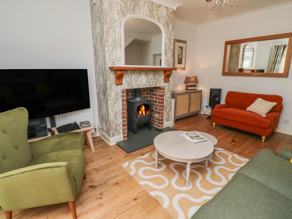 A living room with a fireplace and furniture at 5 Jackson Terrace in Morpeth