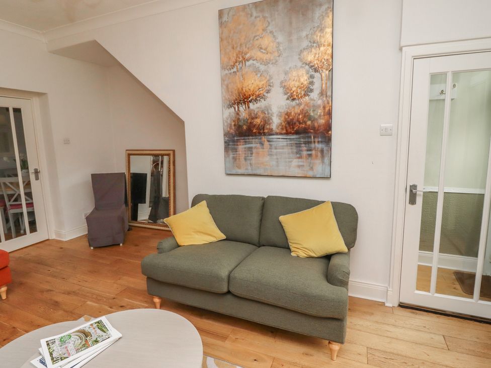 A living room with a sofa and artwork at 5 Jackson Terrace, Morpeth