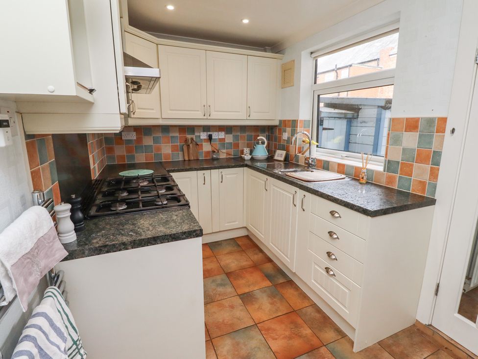 A kitchen with cabinets and a stove at 5 Jackson Terrace in Morpeth
