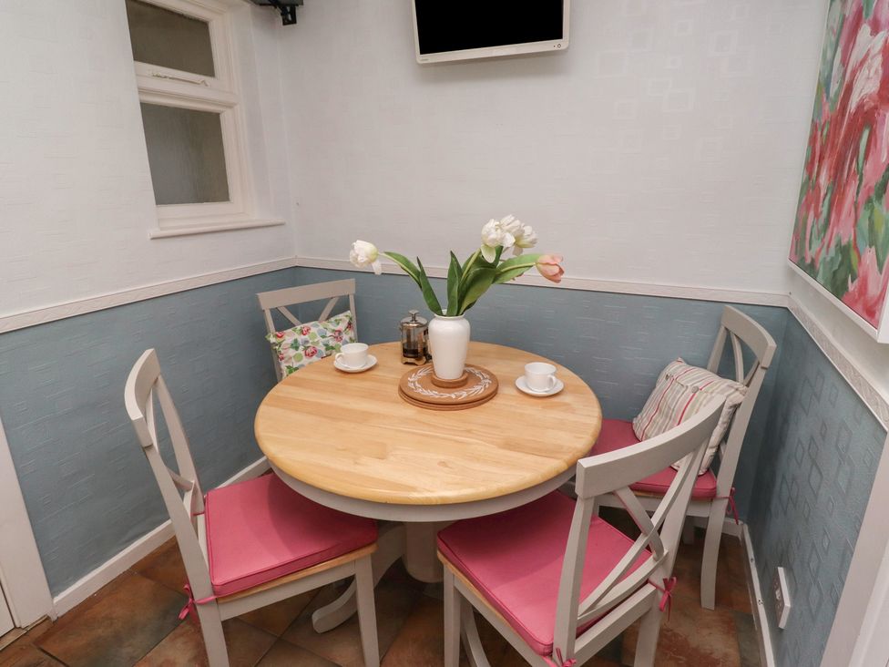 A dining room with a round table and chairs at 5 Jackson Terrace Morpeth