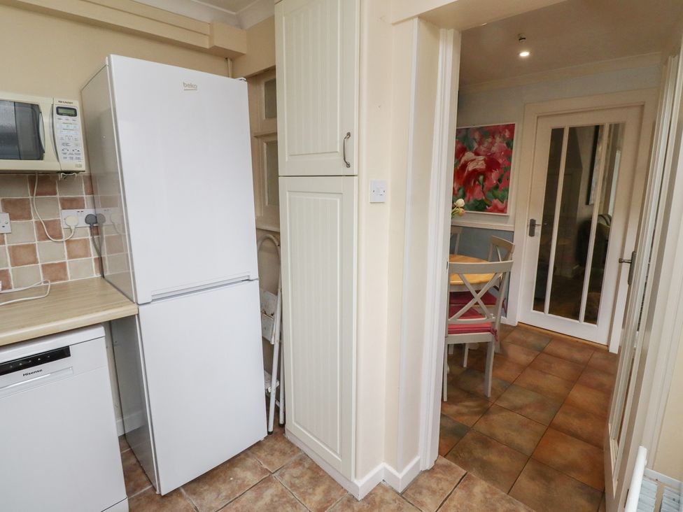 A kitchen with appliances and entrance to a dining area at 5 Jackson Terrace Morpeth