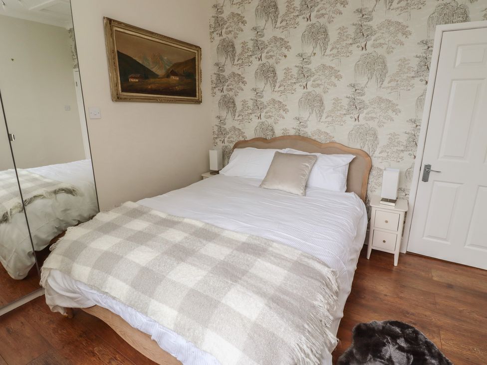 A bedroom with a bed and bedside table at 5 Jackson Terrace in Morpeth