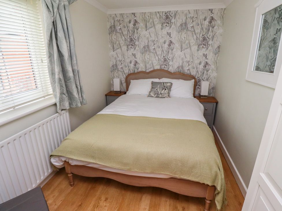 A bedroom with a bed and bedside table at 5 Jackson Terrace in Morpeth