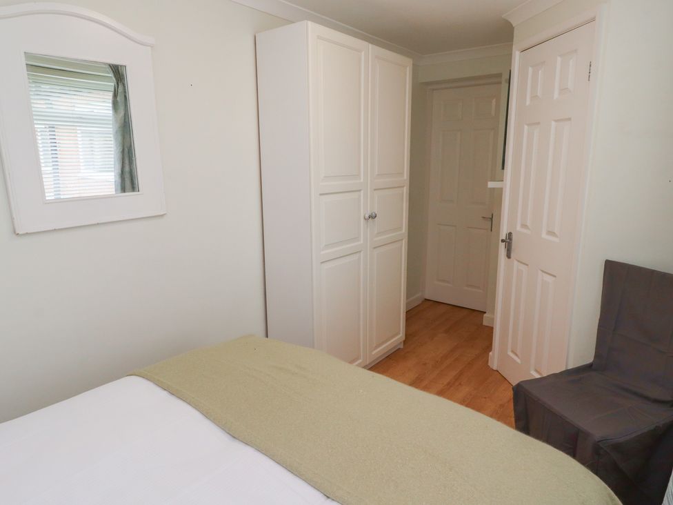 A bedroom with a bed and wardrobe at 5 Jackson Terrace Morpeth