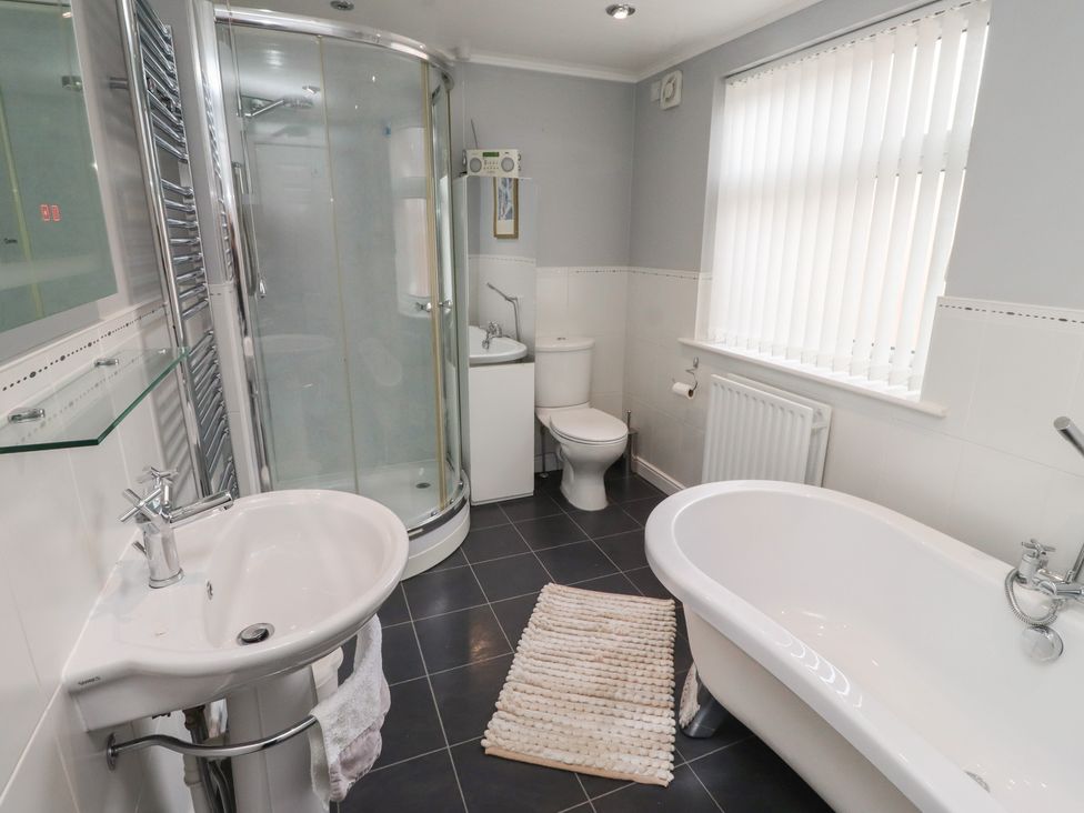 A bathroom with a shower, sink, toilet, and bathtub at 5 Jackson Terrace in Morpeth