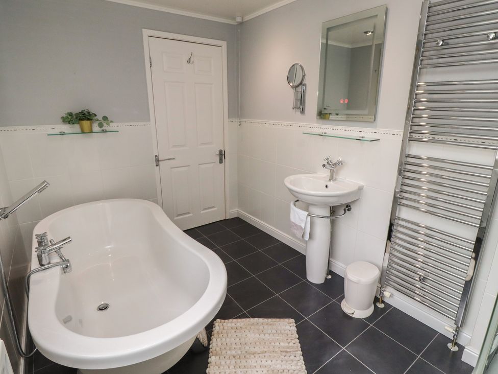 A bathroom with a bathtub and sink at 5 Jackson Terrace Morpeth
